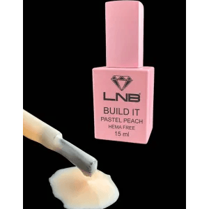A bottle of Build It Pastel Peach Hema Free LNB gel nail polish with a pink label and cap, accompanied by a small amount of liquid gel displayed in front.